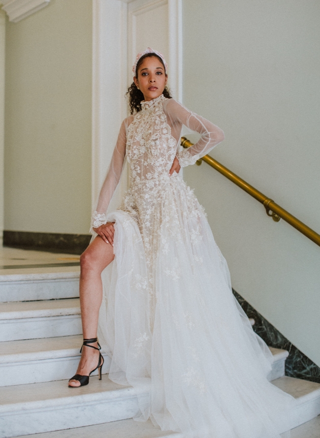 model in floral applique wedding dress slit to thigh on stairs