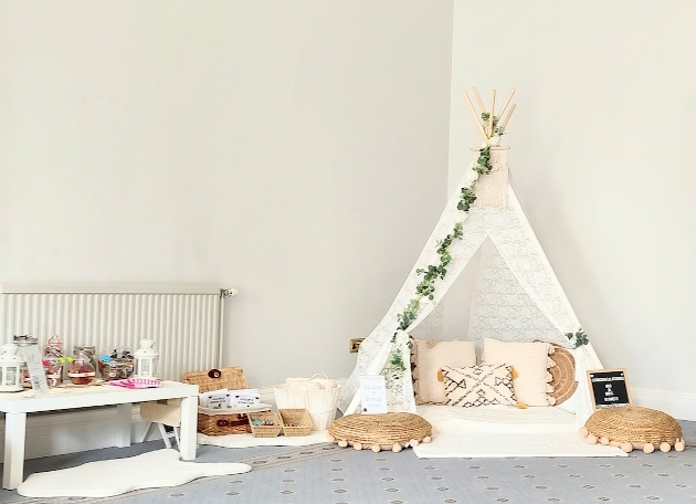 Small white tipi with cushions