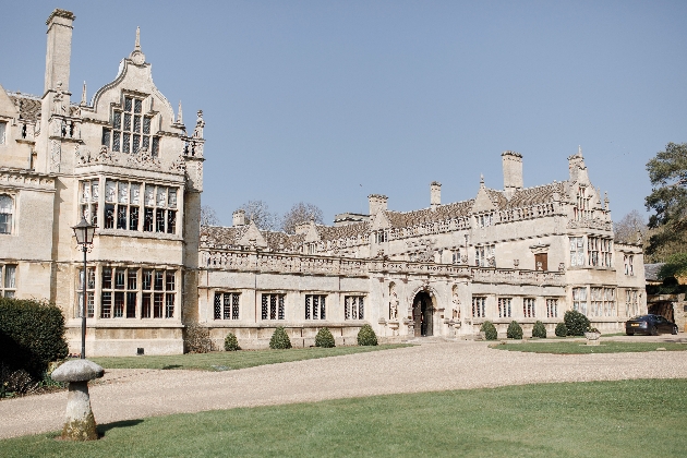 large historic house sunny day lawns to front