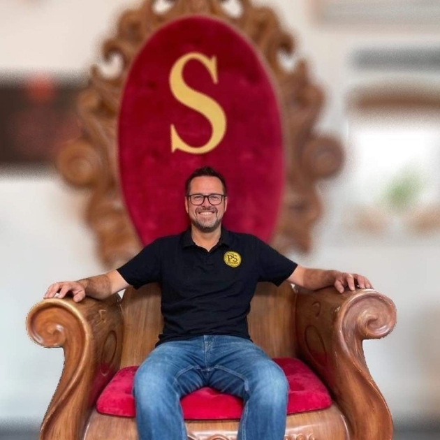 Drew sitting on a large throne