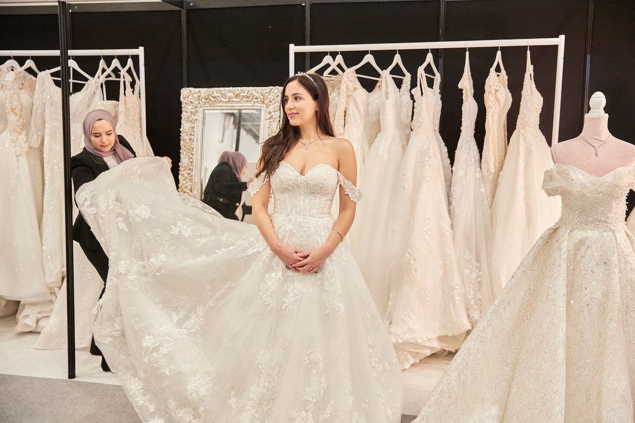 bride trying on wedding dresses