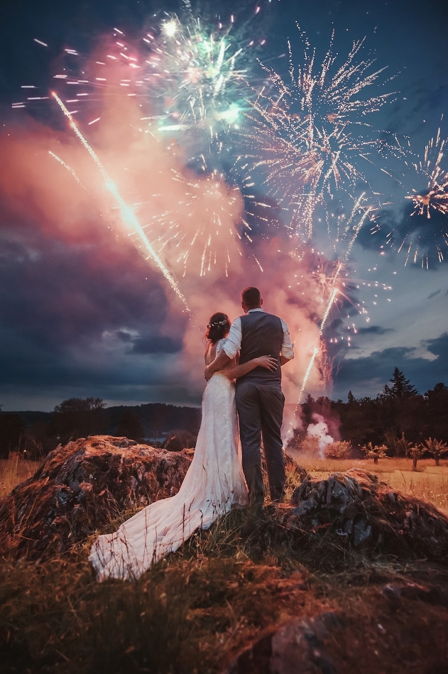 Bride and groom watching fireworks