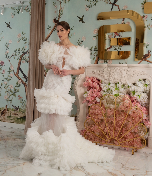 model in fishtail dress with puffy sleeves, waist and skirt