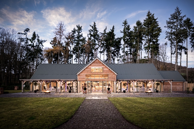 The exterior of a barn with a grey roof