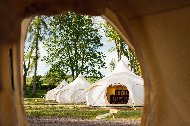 Three white glamping pods