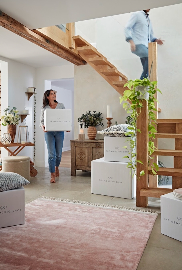 couple moving gift boxes in their house