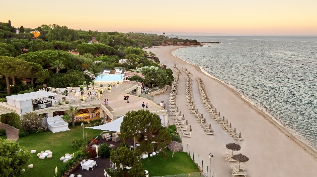 A birds eye view of a beach and a white building