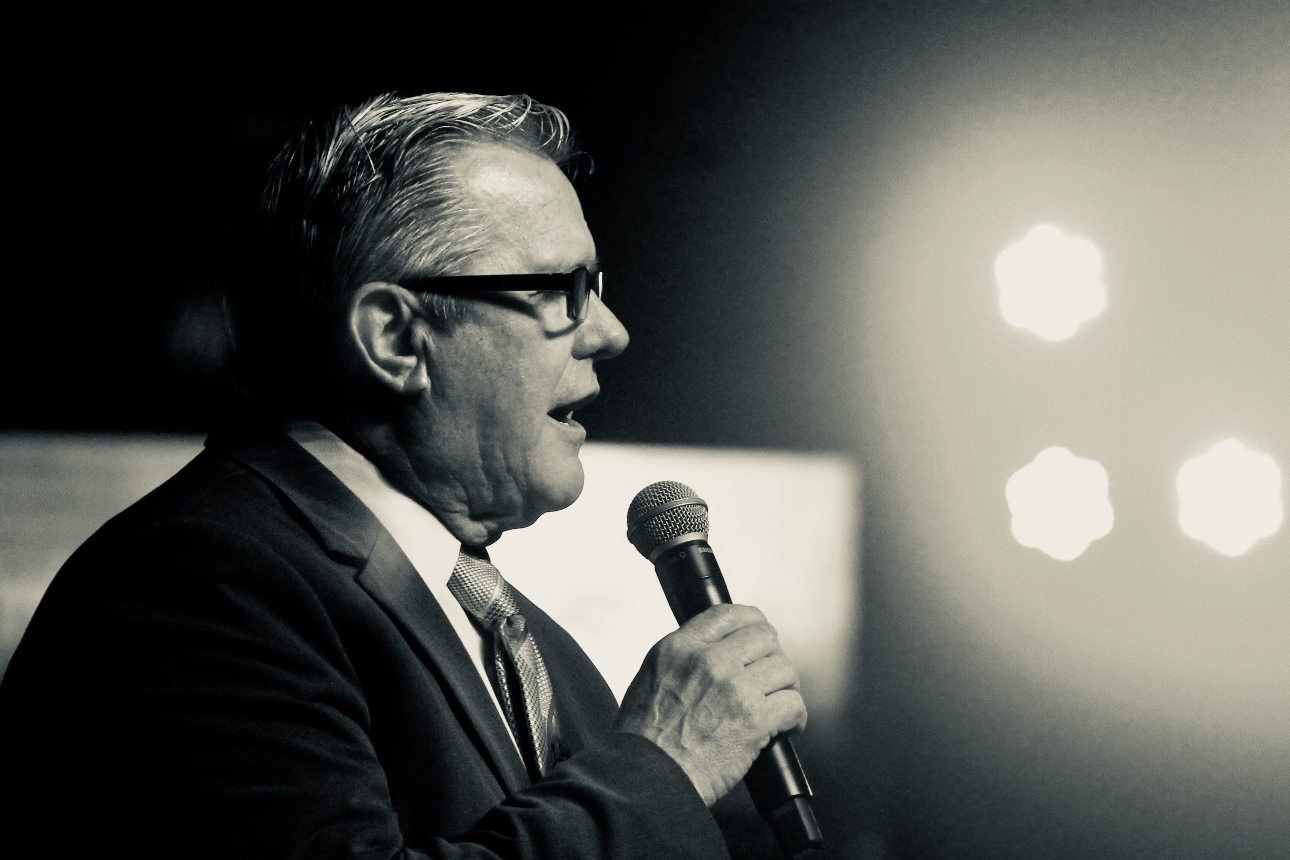 man in a suit giving a speech